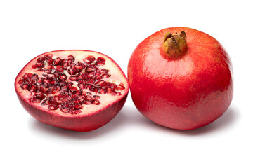 Whole and halved red ripe pomegranate isolated  on white background close up
