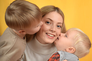 happy mother hugs her little sons