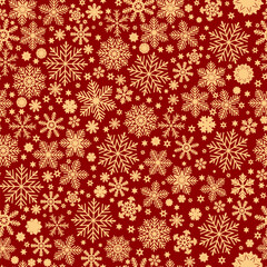 Seamless Christmas pattern with gold snowflakes on red background.