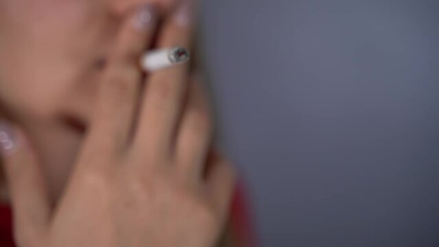 The girl smokes a cigarette. Slow Motion