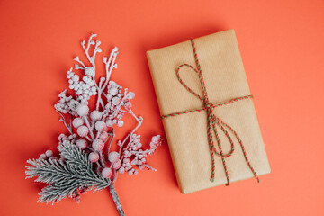 Greeting Christmas background. Gifts wrapping in brown paper on a red background. Top view