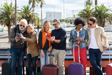 Group of tourists using cell phones in the city - Family friends traveling with smartphone app