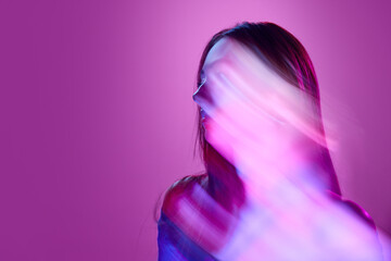 Portrait of young girl posing against light purple background in neon lights. Mixed lights effects. Silhouette. Concept of art, modern style, cyberpunk, futurism and creativity - obrazy, fototapety, plakaty
