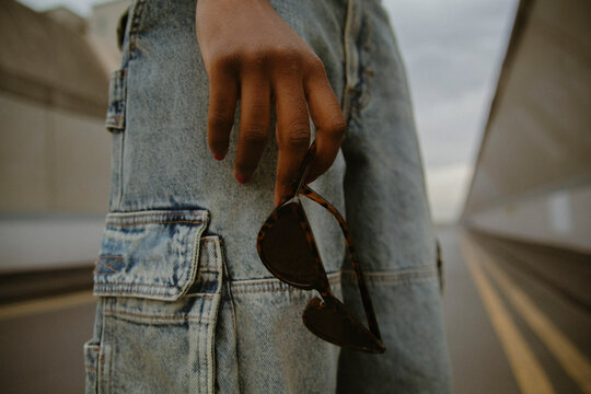 Closeup of hand holding trendy sunglasses