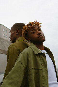 Analogue style portrait of two fashionable black men posing in the city