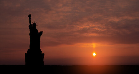 Statue of Liberty on background of sunset sky. Greeting card for Independence Day. USA celebration.