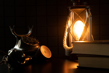 Vintage lamp and telephone. A study with rarities. A cozy atmospheric photo that transports us to another century - obrazy, fototapety, plakaty