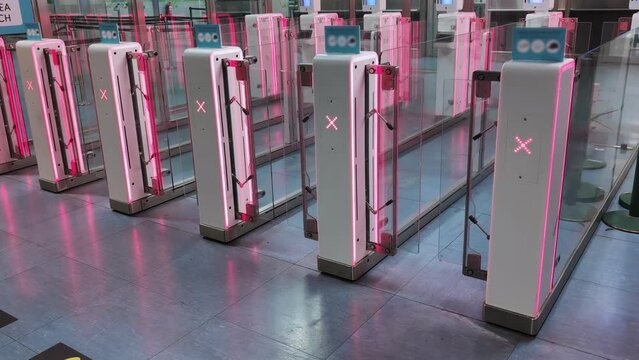 Airport security with closed turnstiles doors featuring X signs, restricting access to ensure safety and control limiting entrance to the restricted area