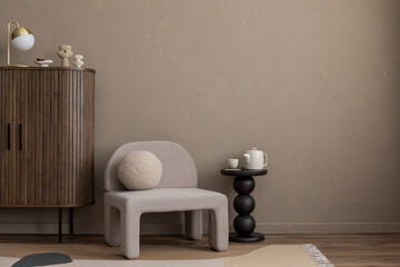 Minimalist composition of aesthetic living room interior with mock up poster frame, copy space, gray armchair, vase with dried flowers, round pillow and personal accessories. Home decor. Template.