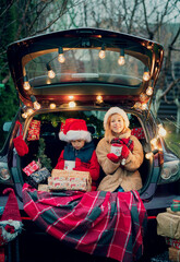 Obraz premium Merry Christmas. children with Christmas gifts outdoors