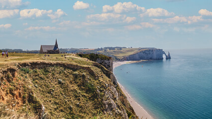 Fototapeta na wymiar Aerial panoramic view of Etretat coastline with white chalk cliffs, natural stone arch and the beach. Etretat, Normandy, France.