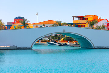 Harbor view of arch bridge over azure blue water with yachts in Cyprus