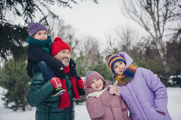 Fototapeta na wymiar Photo of friendly sweet little child wife husband dressed coats visiting together santa claus north pole outdoors urban forest park