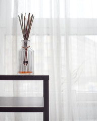 The luxurious glass bottle with the aroma reed diffuser is used as an air freshener in a beautiful...
