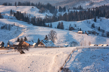 Scenic view of high mountain village in the Carpathians with wooden houses, winter landscape, outdoor travel background