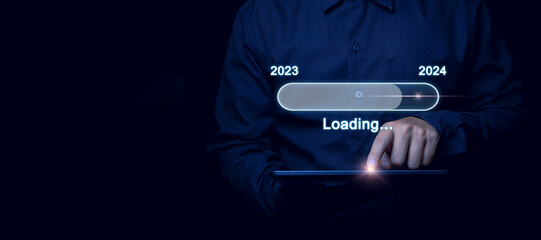 Businessman hand pressing button start 2024. 2024 annual business plan and digital business...