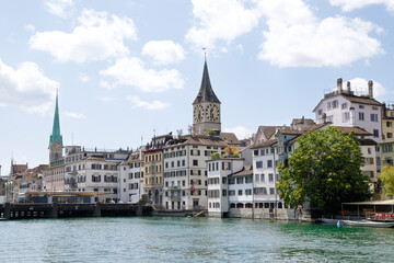 Fototapeta na wymiar View of the historic city center with famous Saint Peter and FraumÃ¼nster Church, on the Limmat river. Zurich, Switzerland.