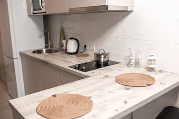 Female janitor with cleaning supplies in kitchen