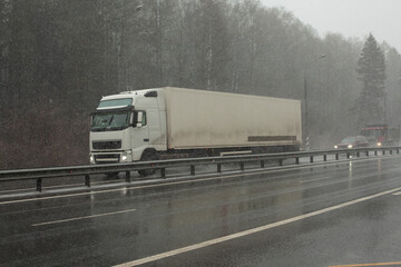 Truck on the highway. Cargo transportation between cities. Big car on the road.