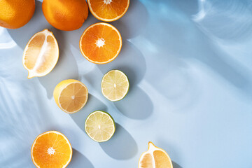 Summer orange cocktails with citrus fruits on blue background. Hard seltzer, lemonade, refreshing...