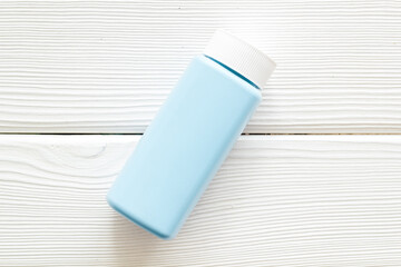 Spilled baby talcum powder. Container with powder for baby body care