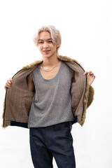 winter faux fur coat. Fashion portrait Asian young man. model, clothing and cosmetics. Young male...