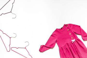 Kids wear flat lay with hangers. Baby fashion concept