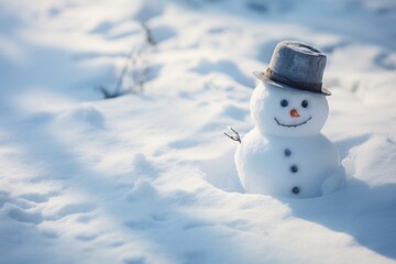 Adorable smiling small snowman in hat standing on a covered with snow field