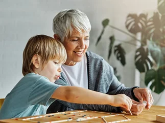 Foto op Canvas grandchild family child grandparent grandmother game playing boy stick pick up board board game grandson creativity education © Lumos sp
