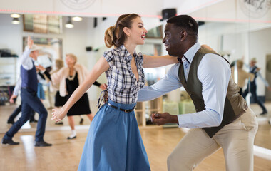 Obraz premium Woman with african man practising charleston dancing