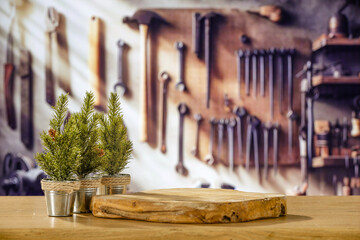 Industrial background of a Christmas workshop. Santa's home and the place where he creates gifts for children. Wooden table and decoration. Blurry background of metal tools and machines for work.  - Powered by Adobe