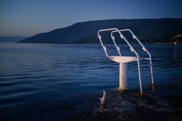 White ladder of a diving board at the beach in Cres
