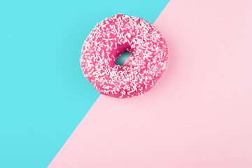 Pink donut on color background, flat lay, top view