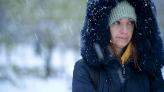 Woman standing outside on a cold snowy day