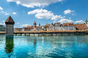 Lucerne, Switzerland - July 10, 2022: View of the Chapel Bridge in historic city of Lucerne,  Switzerland.  One of the main tourist attractions in the city center. - obrazy, fototapety, plakaty