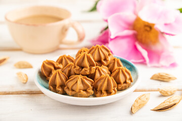 Homemade soft caramel fudge candies on gray concrete, side view, selective focus