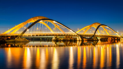 A bridge in the city at night. The bridge against the sky during the blue hour. Architecture and...