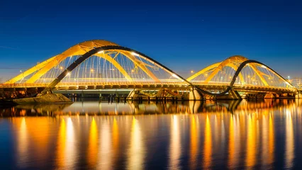 Zelfklevend Fotobehang A bridge in the city at night. The bridge against the sky during the blue hour. Architecture and design. Amsterdam, Netherlands. Panoramic photography for design and background.. © biletskiyevgeniy.com