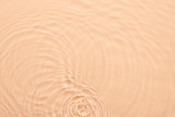 Fototapeta na wymiar Water beige surface abstract background. Waves and ripples texture of cosmetic aqua moisturizer with bubbles.