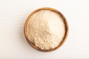 Powdered milk and buckwheat baby food mix, on white wooden, top view