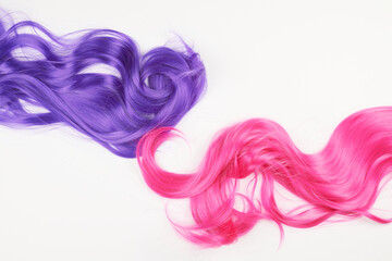 Natural looking shiny hair of different bright colors, cosplay wig on a white background