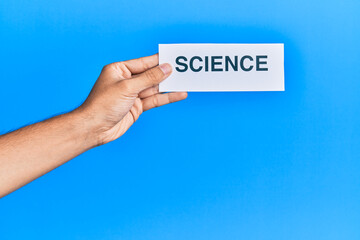 Hand of caucasian man holding paper with science word over isolated blue background