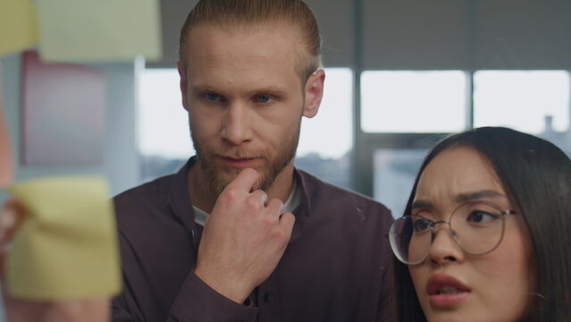 Angry girl disagreeing partner at sticker wall place portrait. Coworkers arguing - Powered by Adobe