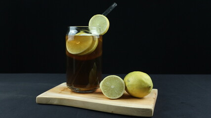 Fototapeta premium Glass of tasty Long Island iced tea on dark background with space for text