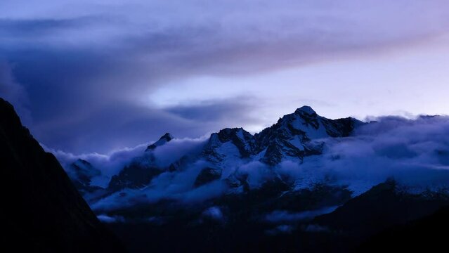 Beautiful Sunset time view time lapse video from Khare village 4950m with running foggy clouds over Himalaya mountains. Makalu Barun National park, Nepal. Beauty in Nature, traveling concept 4K video.