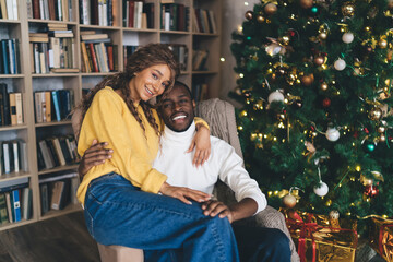 affectionate African-American couple celebrating winter holidays