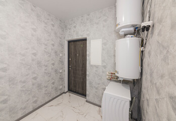 Interior of a utility room with installed two boilers and washing machines