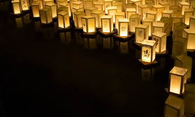 Japanese commemoration of atomic bombs with paper lanterns floating on water