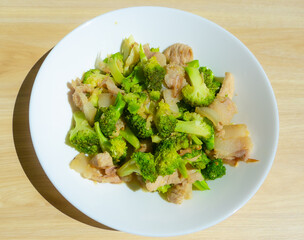 Stir-fried vegetables with pork , Broccoli stir with Thai food style in the white plate.