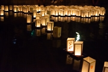 Japanese commemoration of atomic bombs with paper lanterns floating on water